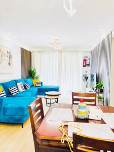 a living room with a blue couch and a table at Urban Homes-Two Bedroom Near JKIA Airport in Nairobi