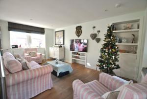 a living room with a christmas tree in the corner at The Old Stables- charming cottage Crail in Crail