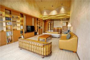 a large living room with a couch and a tv at Bumi Anyom Resort by Nexura in Pikatan