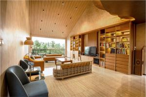 a living room with a couch and a table at Bumi Anyom Resort by Nexura in Pikatan