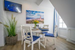 a dining room with a white table and chairs at Lister Tor 11 in List