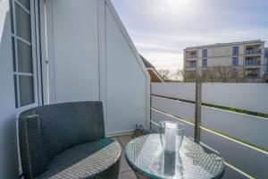 a balcony with a glass table and a chair at Lister Tor 11 in List