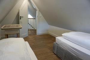 a bedroom with a bed and a stair case at Lachmöwe in List