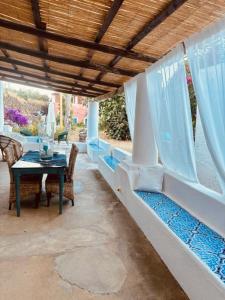 a patio with a table and chairs and a table at Dépendance Liscio in Filicudi