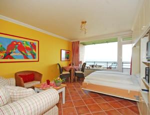 a bedroom with a bed and a living room at Wattenblick 51-35 in List