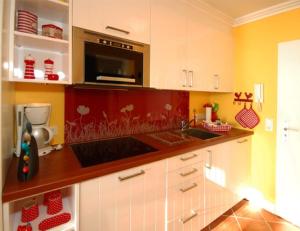 a kitchen with a sink and a microwave at Wattenblick 51-35 in List +1 photo
