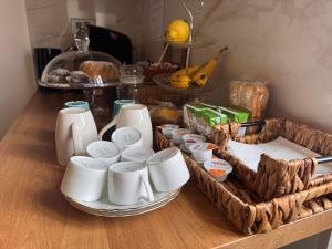 a table with a tray of cups and other food at Cascina 1956 in Palestrina