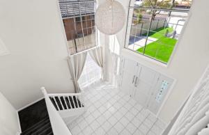 an overhead view of a white staircase with two windows at Darra guest house in Brisbane