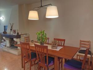 a dining room with a table and chairs and a fireplace at CR TESOL 6 SON - ALT ANEU in Son