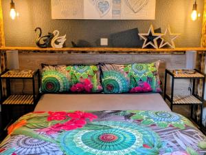 a bed with a colorful comforter in a room at Haus am Wald Radlerrast in Bad Sooden-Allendorf
