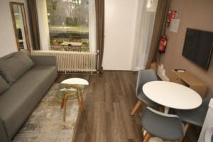 a living room with a couch and a table at Maison-Home-ZuHause in La Calamine