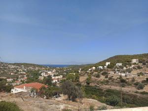a village on a hill with the ocean in the background at V&M Residence Upper Level in Mesagrós