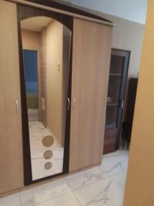 a large mirror in a room with a bathroom at Svečių butas in Šiauliai
