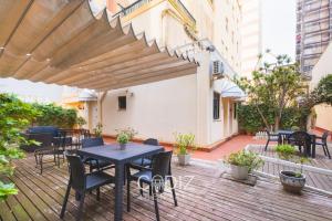 a wooden deck with a table and chairs on it at Hospederia IMAR by Cadiz4Rentals in Cádiz