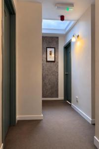 an empty hallway with two doors and a painting on the wall at Boreland Lodge Hotel in Inverkeithing +5 photos