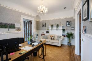 a living room with a couch and a table at Boreland Lodge Hotel in Inverkeithing