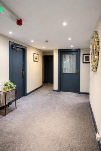 a large room with blue doors and a table at Boreland Lodge Hotel in Inverkeithing
