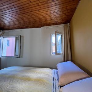 a bedroom with a bed and two windows at Cavour 66 Apartment in Ventimiglia