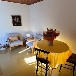 a living room with a table with a vase of flowers on it at Cavour 66 Apartment in Ventimiglia