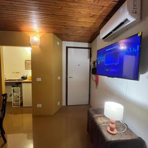 a room with a flat screen tv on the wall at Cavour 66 Apartment in Ventimiglia +23 photos