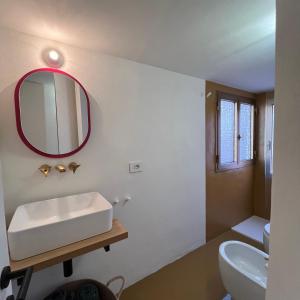 a bathroom with a sink and a mirror on the wall at Cavour 66 Apartment in Ventimiglia