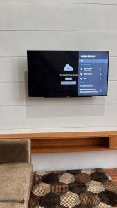 a flat screen tv hanging on a wall at Asokabin House in Diyeng