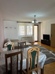 a living room with a dining room table and chairs at One Love 2 in Sarajevo