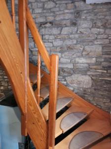 a wooden staircase in a room with a stone wall at Gröningen in Gröningen