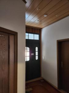 a hallway with a black door and a window at Gröningen in Gröningen