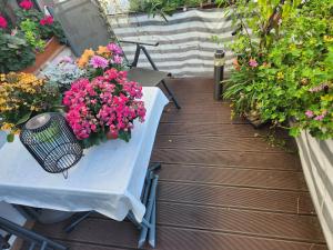 a table and chairs with flowers on a deck at Gröningen in Gröningen