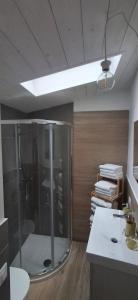 a bathroom with a glass shower and a sink at Casa APOLLO in Palmanova