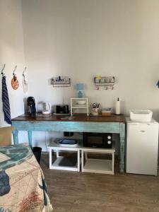 a room with a blue table with a microwave at The Corner Pavillon in Noirmoutier-en-l'lle +17 photos