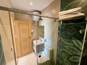 a bathroom with a shower and a toilet and a sink at DouDou Pyramids View Hotel in Cairo +135 photos