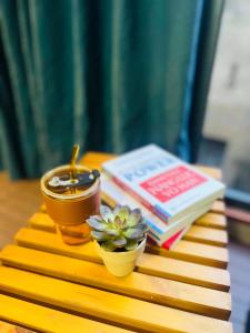 a table with a book and a potted plant and books at Saigon Quiet Stay in Ho Chi Minh City +34 photos
