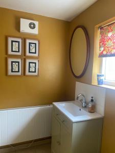 a bathroom with a sink and a mirror at 1 Penygroes in Penmachno +23 photos
