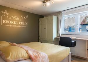 a bedroom with a bed and a window at B&B Keukja Cuijk in Cuijk