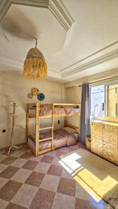 a bedroom with two bunk beds and a chandelier at Endless Wave Morocco in Agadir