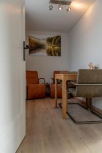 a living room with a table and a couch at B&B Keukja Cuijk in Cuijk +15 photos