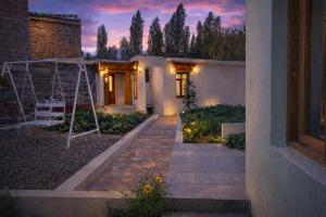 a house with a swing in the yard at night at RH Guest House Leh in Leh