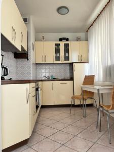 a kitchen with white cabinets and a table and chairs at Ferienwohnung in Misdroy/Ostsee in Międzyzdroje +38 photos