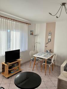 a living room with a tv and a table at Ferienwohnung in Misdroy/Ostsee in Międzyzdroje