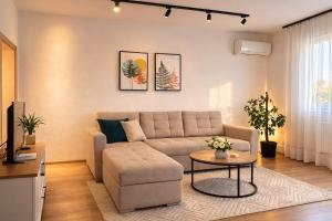 a living room with a couch and a table at Apartmani Sun & Moon in Žepče