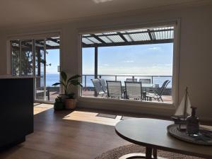 a living room with a view of the ocean at Five Little Ducks in Adventure Bay