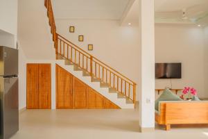 a staircase in a living room with a couch at Dolphin - New luxury rooms in Lovina Centre & near the beach in Lovina