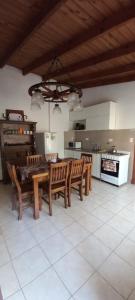 a dining room with a table and chairs in a kitchen at Cabañas del Gordo in Mar del Plata
