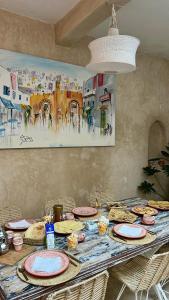 a table with plates of food on top of it at Authentic Riad - Sea View & Rooftop Spa in Essaouira +28 photos