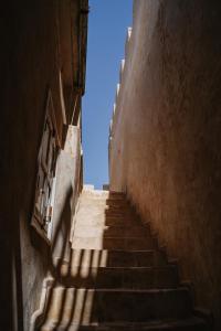 an alley with stairs leading up to a building at Authentic Riad - Sea View & Rooftop Spa in Essaouira