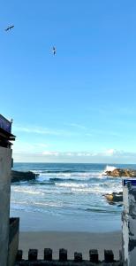 a view of a beach with the ocean at Authentic Riad - Sea View & Rooftop Spa in Essaouira