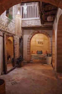 a living room with a couch in the middle of a building at Authentic Riad - Sea View & Rooftop Spa in Essaouira