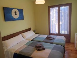 a bedroom with two beds with towels on them at CR TESOL 6 SON - ALT ANEU in Son